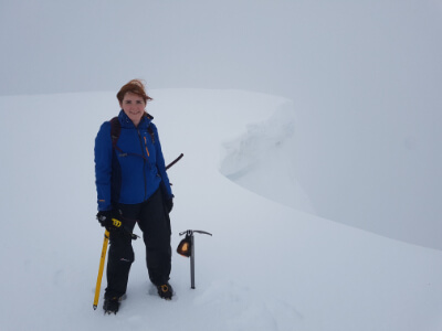 Photo of Elspeth hikinh on a snowy mountain