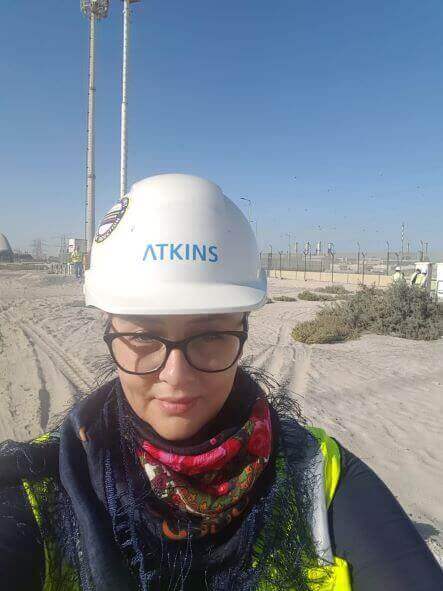Photo of Alexandra smiling towards the camera on site
